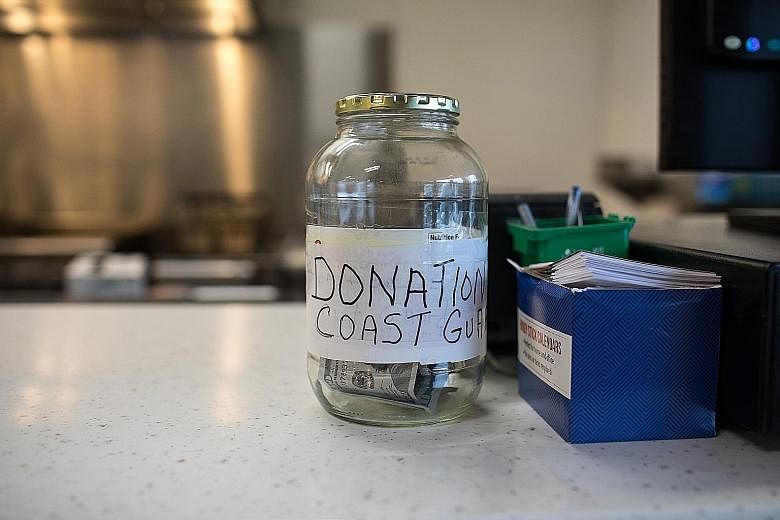 A donation jar for coast guards at King's Diner in Kodiak, Alaska, last Wednesday. The shutdown has brought a particular chill to the small town, which depends on the Coast Guard base. A queue last Thursday outside chef Jose Andres' World Central Kit