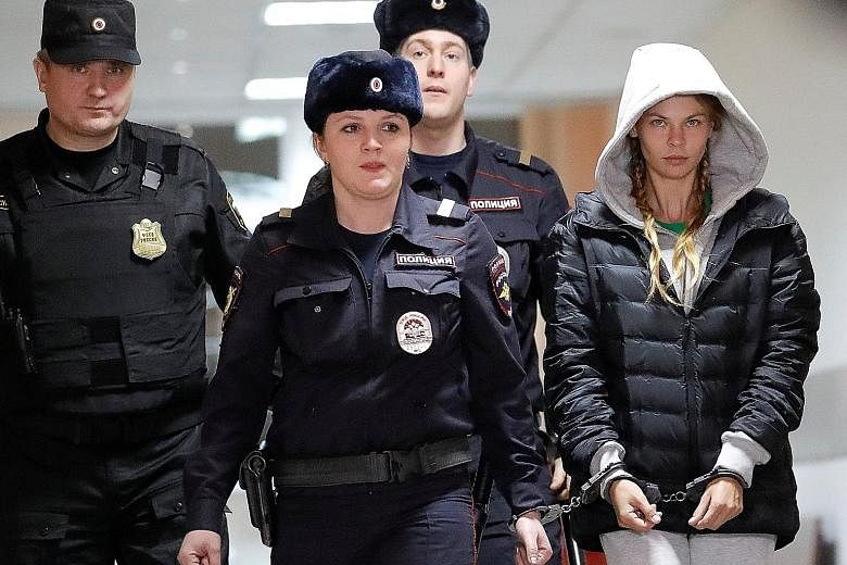 Belarusian model Anastasia Vashukevich being escorted before a court hearing in Moscow yesterday. She was convicted in Thailand last week after she pleaded guilty to multiple charges, including soliciting and illegal assembly. She claimed to have pro