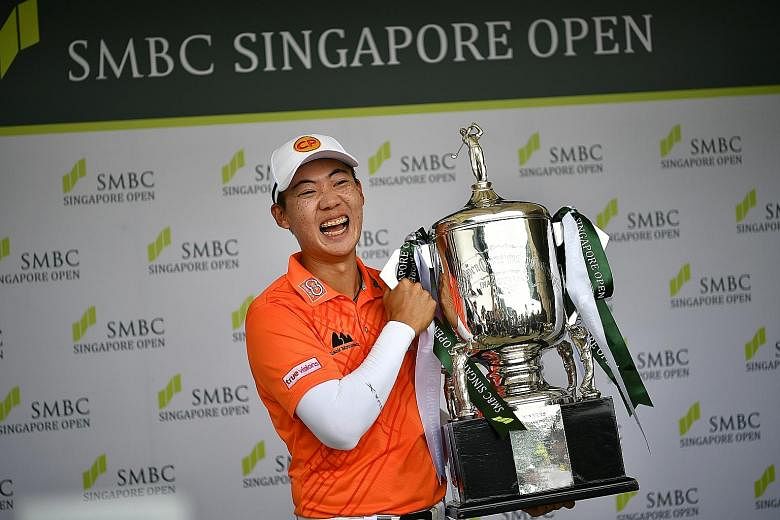 Jazz Janewattananond posing with the SMBC Singapore Open trophy yesterday. The 23-year-old Thai's 18-under 266 total was the lowest winning score at Sentosa Golf Club's Serapong Course, surpassing the 17-under 267 set by three-time Singapore Open win