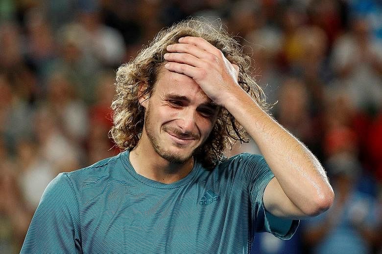 Greece's Stefanos Tsitsipas (left) in disbelief after his shock fourth-round win over defending champion Roger Federer at the Australian Open yesterday.