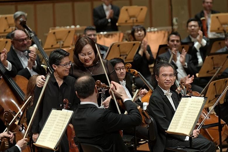 Musicians Lim Shue Chern (left) and Lynnette Seah receiving applause at the SSO 40th-anniversary concert.