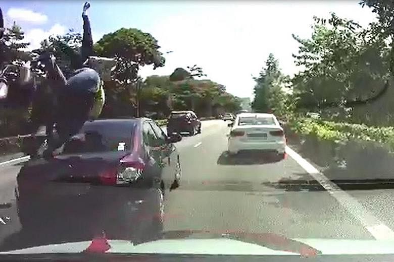 A dashcam video sent to Lianhe Wanbao showed the motorcyclist landing on the car after he collided with it. His pillion rider was flung in front of the car.