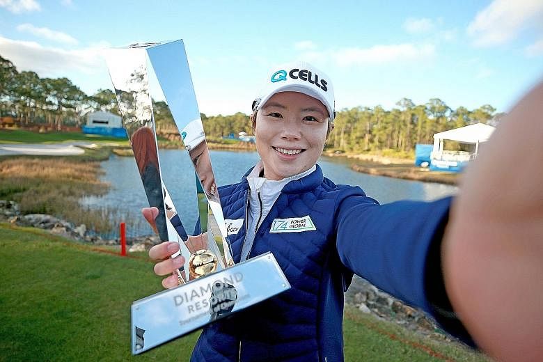 Ji Eun-hee pretending to take a selfie with the trophy after winning the Tournament of Champions on Sunday.