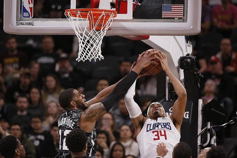 Los Angeles Clippers' Tobias Harris challenges San Antonio Spurs' LaMarcus Aldridge for a rebound. The Spurs centre led all scorers with 30 points but it was not enough to prevent the Clippers beating them 103-95 at the AT&T Centre in San Antonio.