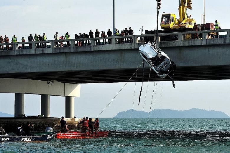 The recovery team used four cables attached to a crane to lift the Mazda CX-5 SUV, submerged at a depth of 15m, out of the water. The body of 20-year-old college student Moey Yun Peng was found in the driver's seat. The car had plunged into the sea a
