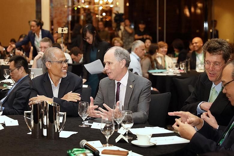 Minister for the Environment and Water Resources Masagos Zulkifli with British High Commissioner to Singapore Scott Wightman at the Unlocking Capital for Sustainability forum at St Regis hotel yesterday. Mr Masagos noted that sustainability efforts m