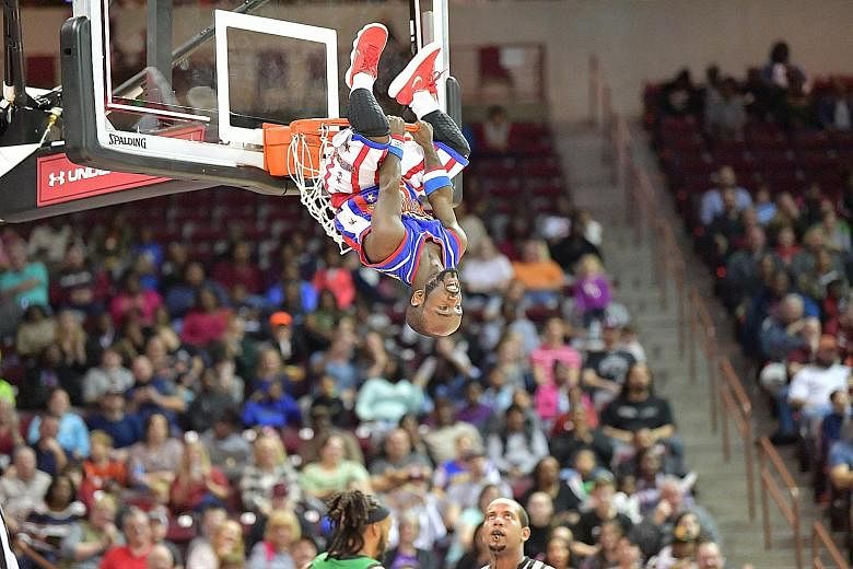 Harlem Globetrotters' 1.35m guard Jahmani "Hot Shot" Swanson after a dunk. The Globetrotters, who were last here in 2009, will play the Washington Generals, who are part of their travelling crew, on April 5.