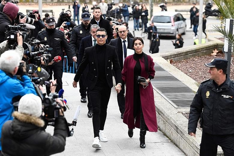 Cristiano Ronaldo arriving at the court hearing in Madrid yesterday along with his partner Georgina Rodriguez.
