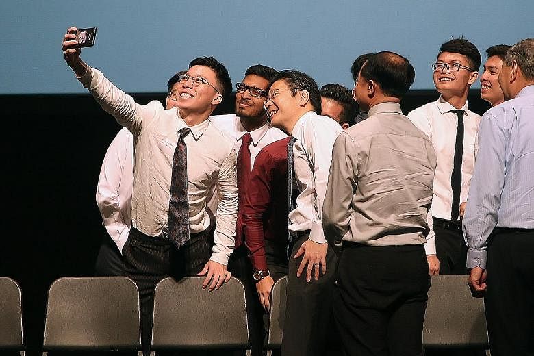 Scholarship and sponsorship recipients taking a wefie with National Development Minister Lawrence Wong (fourth from left) at the iBuildSG scholarship ceremony at the National University of Singapore yesterday.