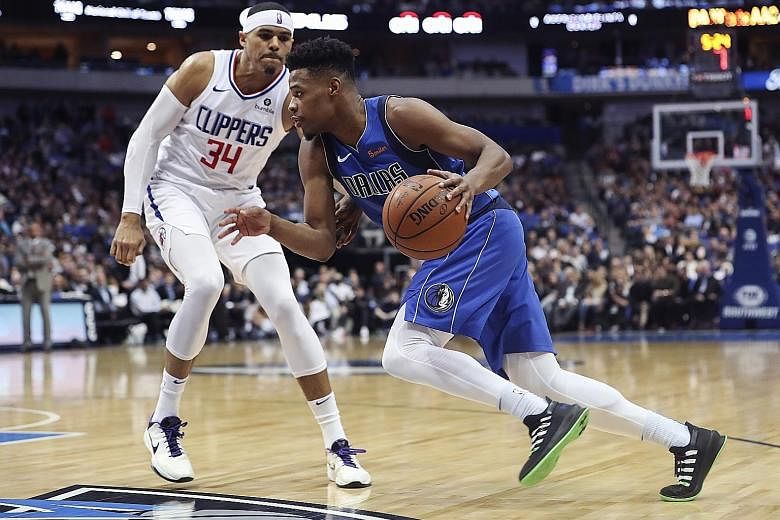Dallas Mavericks guard Dennis Smith Jr driving to the basket past LA Clippers forward Tobias Harris at the American Airlines Centre. The Mavericks won 106-98 to improve to 21-26.