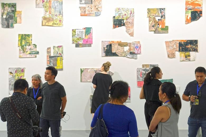 Visitors at the preview of the S.E.A. Focus art fair yesterday. Last week, organisers of Art Stage Singapore, another art fair, cancelled the event that was supposed to have run from tomorrow to Sunday. Since the cancellation, there has been a ground