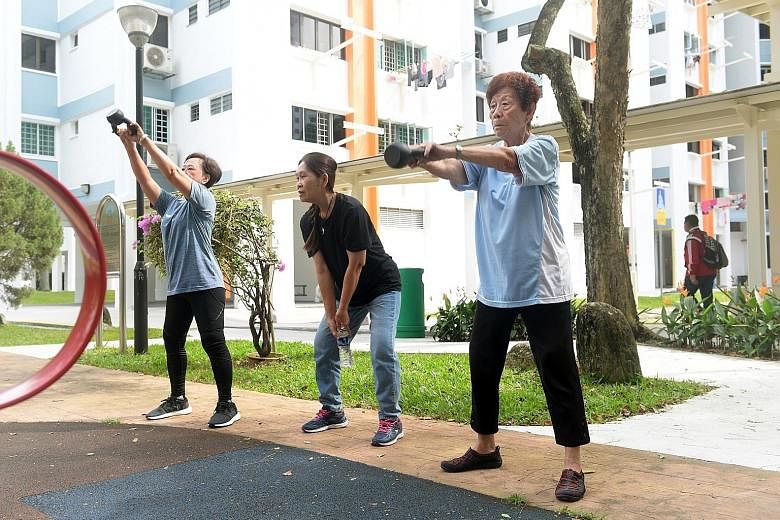 Yeoh Kim Bee (far right) and 10 other seniors are part of the CrossFit programme at the House of Joy elderly activities centre in Mountbatten. The exercise classes aim to give the elderly the confidence to lead independent lives. SCAN TO WATCH Meet t