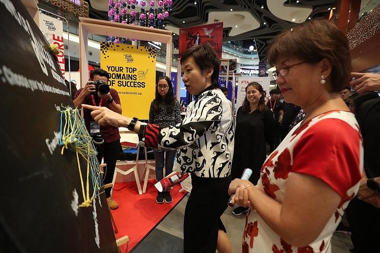 Minister for Culture, Community and Youth Grace Fu (left) and Ms Denise Phua, Mayor of Central Singapore District, at one of the booths at the Todo Todo Skills Marketplace fair yesterday. Todo Todo is a career support initiative started by NTUC and t