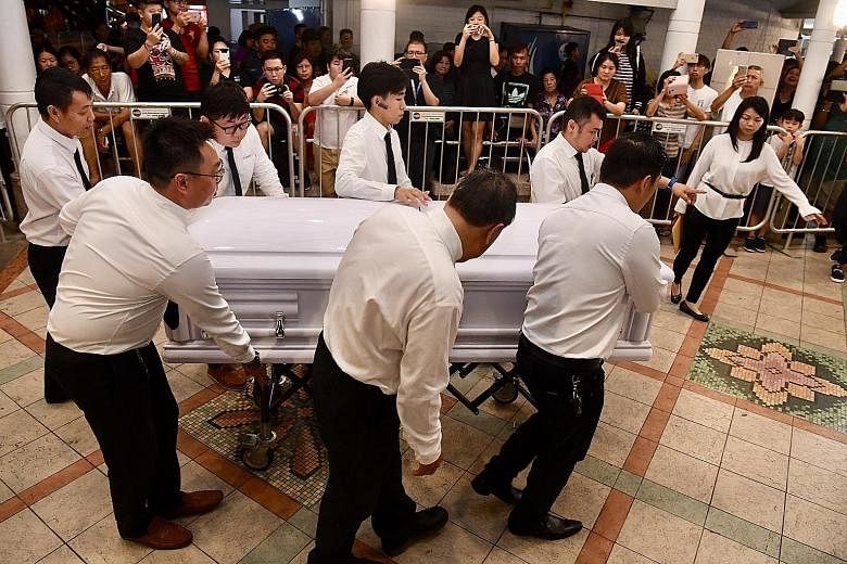 A large crowd of mourners outside the wake area last night. The public memorial for actor Aloysius Pang will be held at 82A MacPherson Lane from noon today to noon tomorrow. Mr Pang's close friends and relatives paying their last respects at the wake