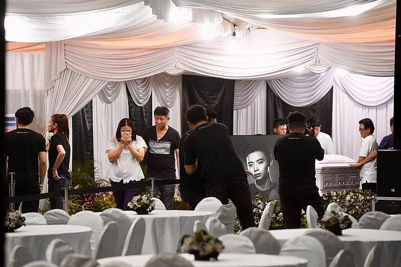 A large crowd of mourners outside the wake area last night. The public memorial for actor Aloysius Pang will be held at 82A MacPherson Lane from noon today to noon tomorrow. Mr Pang's close friends and relatives paying their last respects at the wake
