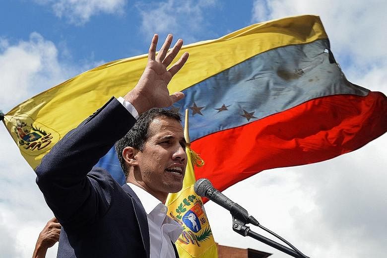 Venezuela's National Assembly head Juan Guaido (above) proclaimed himself "acting president" on Wednesday but President Nicolas Maduro (right) still has the loyalty of the powerful military.