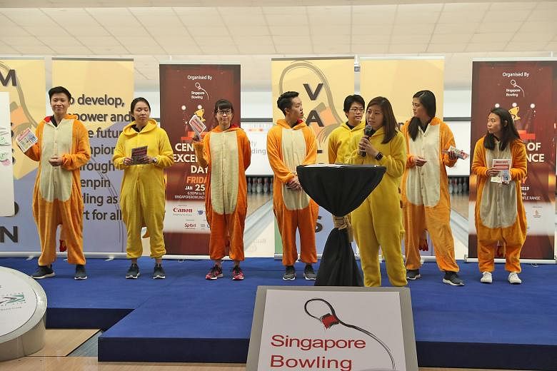 The national women's bowling team - under the Carrying Moments banner - sharing about Project Uplift, an initiative to buy, pack and distribute festive packs to the less fortunate this Chinese New Year, during last night's COE Day celebration. The ev