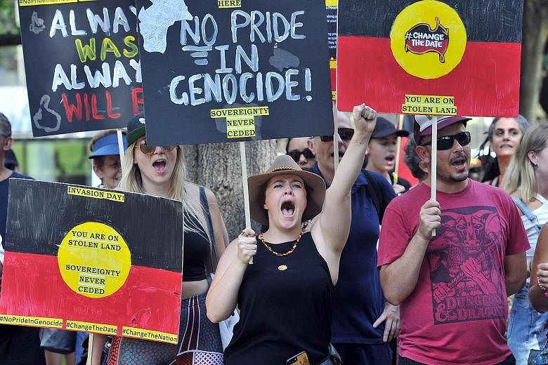 Protesters shouting slogans while marching through the streets of Sydney yesterday at an "Invasion Day" rally. Thousands joined rallies across Australia calling for an end to the celebration of Australia Day on Jan 26, which marks the declaration of 