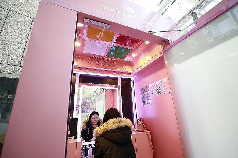 Chinese customer Fu Jie, 28, trying out make-up in a "shareable make-up" pod operated by 17Beauty, or Seventeen Beauty, at a mall in Beijing. Such pods are the latest fad to enter China's large sharing economy, aimed at young urban women on the go. C