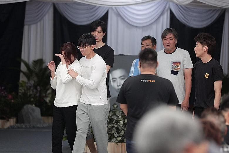 Actor Aloysius Pang's mother with other family members at his wake yesterday in MacPherson Lane. Mr Jefferson Pang, the actor's eldest brother, said in his eulogy that their mother doted on Aloysius a lot because he was the youngest.