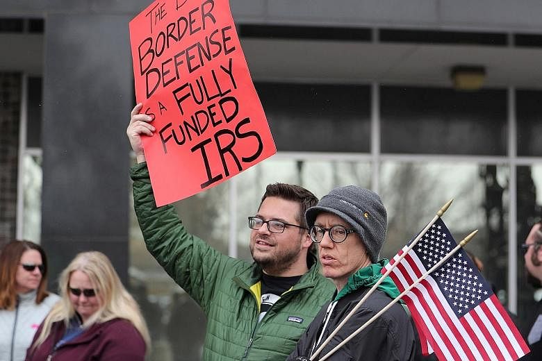 US Internal Revenue Service (IRS) employees protesting earlier this month against the US partial government shutdown. The 35-day shutdown, which ended last Friday, has taken its toll on several key US agencies, including the IRS and the Bureau of Eco