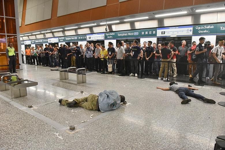 A gunman and a suicide bomber, both role players, lying dead on the floor at the platform of Tampines West MRT station where anti-terror drill Exercise Quicksand was held yesterday.