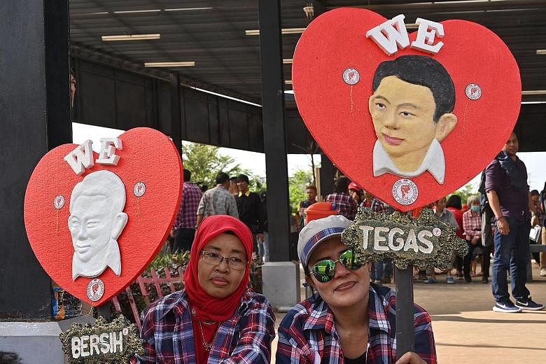 Supporters of former Jakarta governor Basuki Tjahaja Purnama celebrating his release from prison last Thursday. Mr Basuki is being accused of making the Muslim woman he plans to marry commit apostasy.