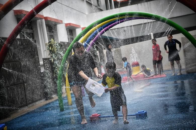 Children enjoying an activity in the Wet Play Area at the Awwa Early Intervention Centre yesterday. When the subsidies are revised, early intervention fees will range from $5 to $430 per month, down from $5 to $780 per month currently.
