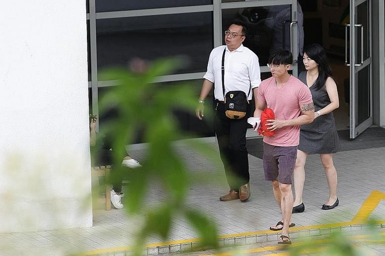 Mr Pang's eldest brother, Mr Jefferson Pang (in pink), leaving Mandai Crematorium yesterday with the late actor's ashes.