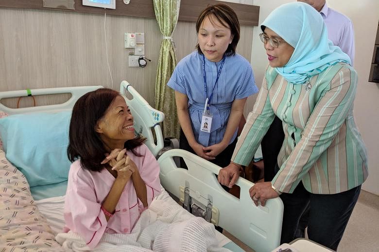 Cancer patient Mary Tang with President Halimah Yacob and Dover Park Hospice medical director Ong Wah Ying. The support of hospice staff, volunteers and fellow residents helped Madam Tang come to terms with her mother's death early last month.