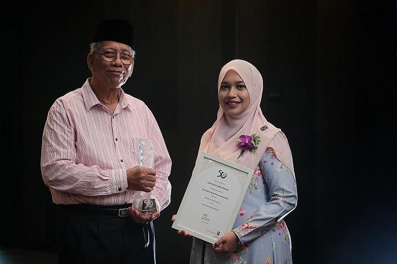 Mr Ma'mun Suheimi received the Muis50 Contemporary Madrasah Leader Award and Ms Liyana Abdul Rahaim was presented with the Muis Social Work Study Award during the Madrasah Teachers Symposium at Suntec Convention Centre yesterday.