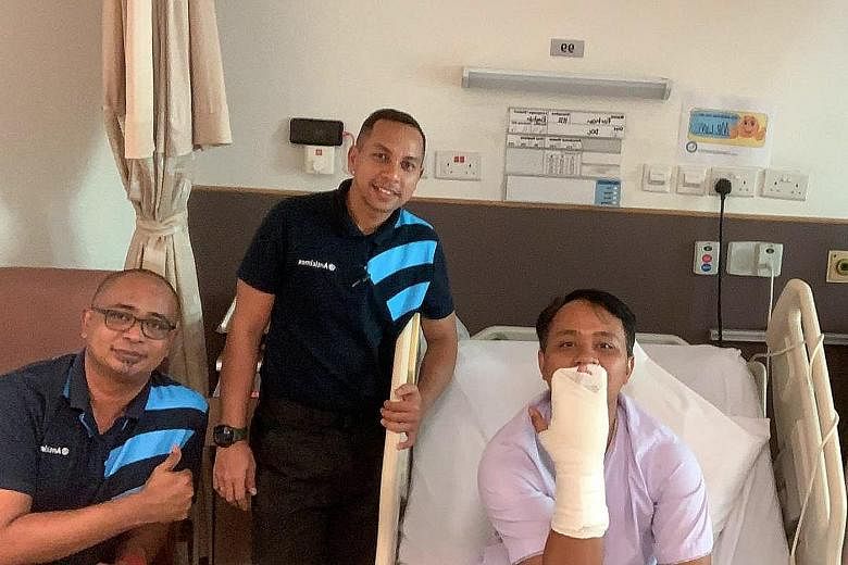 A pest control worker was bitten while capturing the python on Tuesday (above). The firm said yesterday the worker Farhan (left) had undergone surgery to remove an embedded snake tooth.
