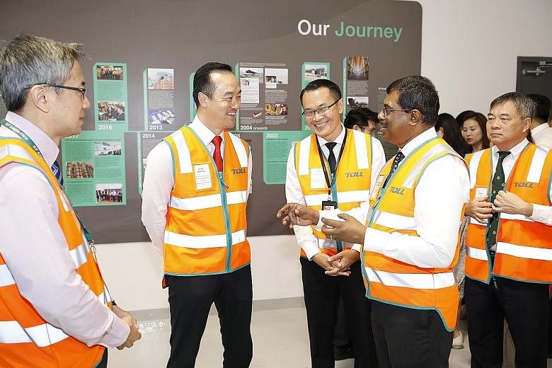 Senior Minister of State for Trade and Industry Koh Poh Koon with ST Logistics chief executive (designate) Loganathan Ramasamy during a tour yesterday of Toll City, a next-generation logistics hub in Tuas.
