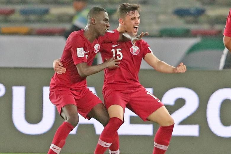 Qatar's Almoez Ali (left) celebrating with Bassam Al-Rawi after scoring his second goal in the 2-0 group-stage win over Saudi Arabia at the Zayed Sports City Stadium in Abu Dhabi on Jan 18. The United Arab Emirates has formally questioned the eligibi