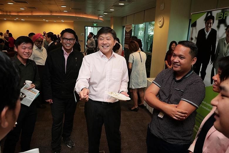 NTUC secretary-general Ng Chee Meng (centre) and assistant secretary-general Patrick Tay (in black jacket) before the start of the Future Jobs, Skills and Training Forum yesterday.
