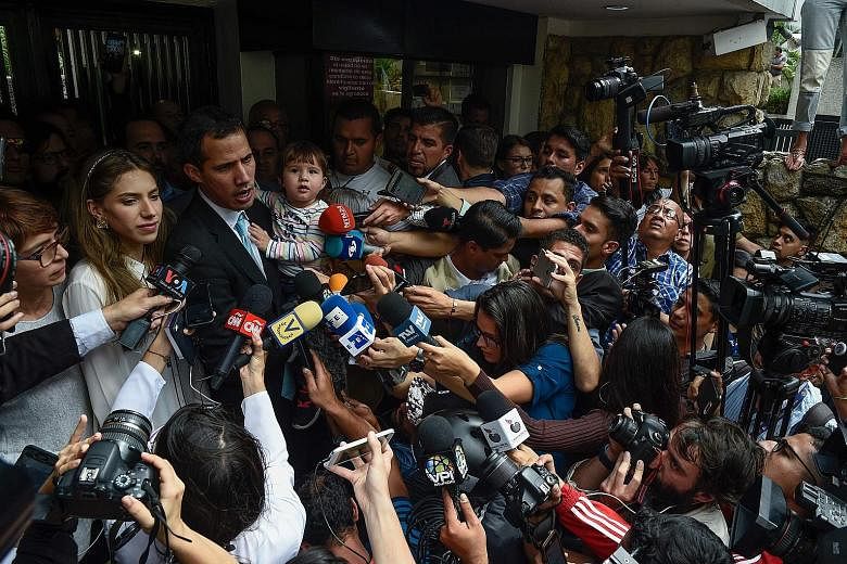 Opposition leader and self-proclaimed "acting president" Juan Guaido, seen here with his daughter Miranda and wife Fabiana Rosales, has accused socialist leader Nicolas Maduro's security forces of going to his home and trying to intimidate his family