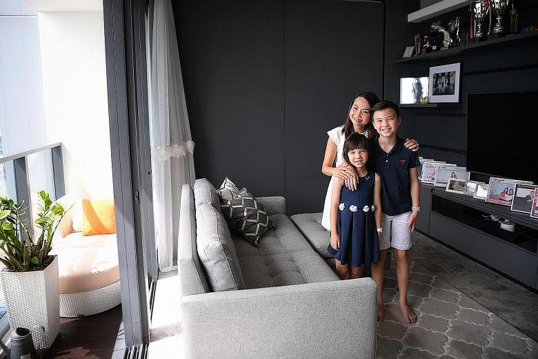 ERA division director Wendeline Goh, with her children - Brandon, 11, and Amelia, seven - at the rooftop of her condominium Skysuites@ Anson. She says the panoramic view of the city from her 68th-floor unit is breathtaking. Ms Goh says her apartment 