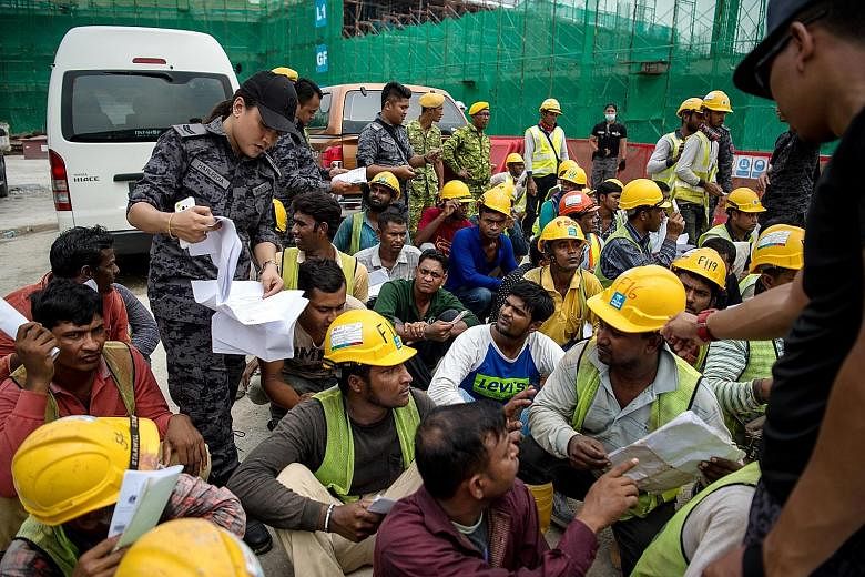 Immigration Department personnel during a raid at a construction site in Kuala Lumpur on Sept 26 to crack down on undocumented foreign workers. Malaysia needs a steady supply of unskilled workers and must repair the damage to the country's reputation