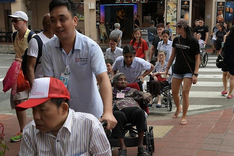 Residents of Thong Teck Home for Senior Citizens, with Jiaksimi volunteers and nursing home staff, on their outing to Chinatown on Jan 26. Started in 2016 and held every couple of months, Jiaksimi gathers volunteers, some as young as 17, to accompany