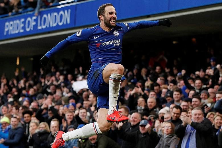 Gonzalo Higuain leaps for joy in front of the Stamford Bridge faithful after netting his first goal in Chelsea colours against Huddersfield yesterday. The Argentinian, making his third appearance for the Blues since moving from AC Milan last month, s