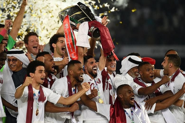 Qatar's players with the trophy after beating Japan 3-1 in the Asian Cup final at the Mohammed Bin Zayed Stadium in Abu Dhabi on Friday. Their head coach Felix Sanchez led Qatar to their first Asian Under-19 title in 2014. They also reached the U-23 