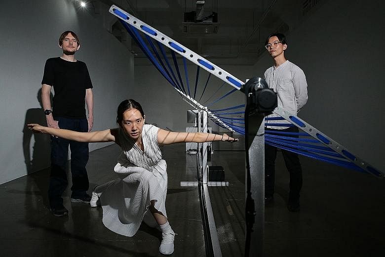 Murasaki Penguin's Anna Kuroda (centre) and David Kirkpatrick (left), and curator Ong Kian Peng (right), with the installation Motion Theory.