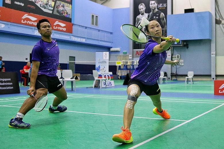 Danny Bawa Chrisnanta and Tan Wei Han in action during the mixed doubles final of the Singapore National Open Championships at the Singapore Badminton Hall last Friday.