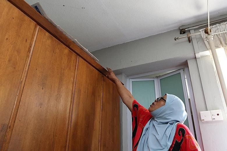 The blood (above) from an elderly man's decomposing body seeped through the ceiling of a flat below his unit in Tampines last Tuesday because of the porous nature of the concrete. The ceiling of the flat belonging to his neighbour Ms Jamilah (right) 
