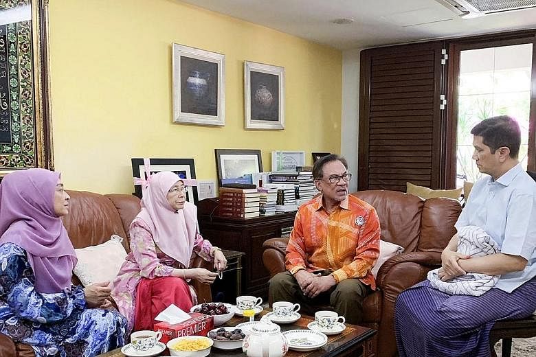 Malaysia's Deputy Prime Minister Wan Azizah Wan Ismail and her husband, PKR president Anwar Ibrahim (both centre), visiting Economic Affairs Minister Azmin Ali, who is convalescing at home from gall bladder surgery, yesterday. With them is Mr Azmin's