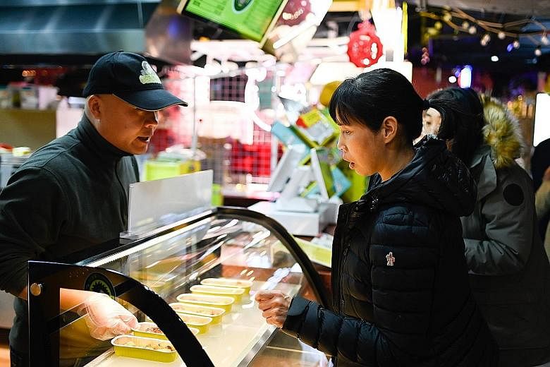 Customers at the Little Fruit Captain durian stall in Beijing last month.