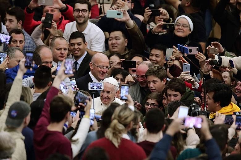 Pope Francis greeting people during his weekly general audience yesterday in Vatican City. The pontiff's public admission on the sexual abuse of nuns by priests and even bishops marks a new chapter in the crisis rocking the Catholic Church. He also a