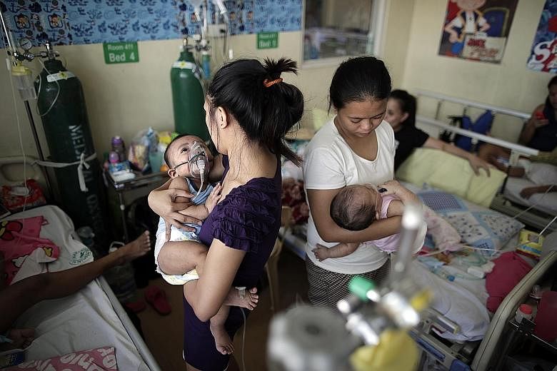 Children with measles in an overcrowded room at a government hospital in the Philippine capital Manila yesterday.