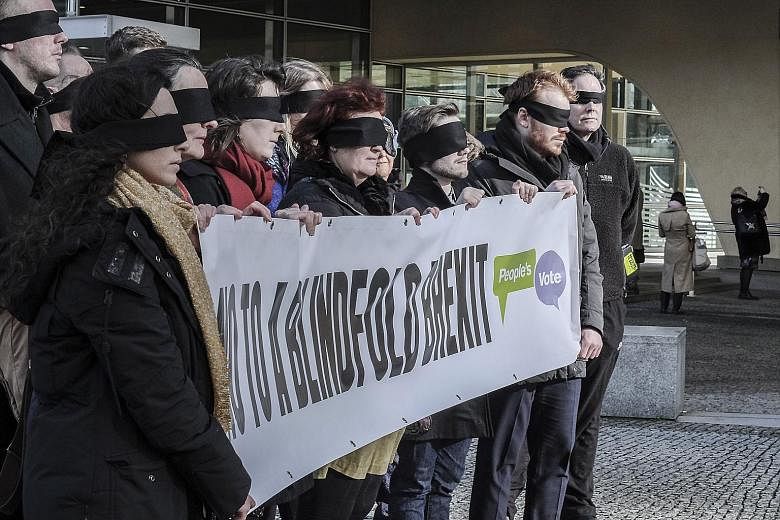 Protesters with a banner reading "No To A Blindfold Brexit" outside the European Commission HQ in Brussels yesterday. EC president Jean-Claude Juncker "expressed his openness to add wording" to a parallel political declaration laying out ambitions fo