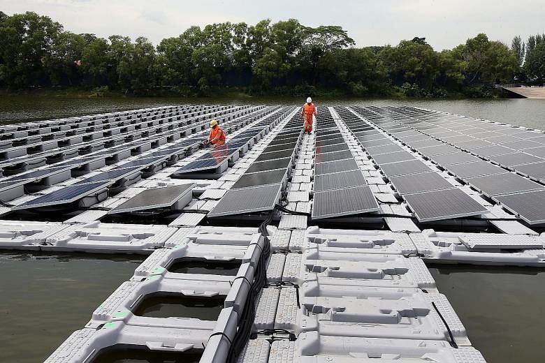A floating solar photovoltaic cell test-bed in Tengeh Reservoir in Tuas in 2016. While such panels cost more to install, they are up to 16 per cent more efficient because the water's cooling effect helps reduce thermal losses and extend their life, a